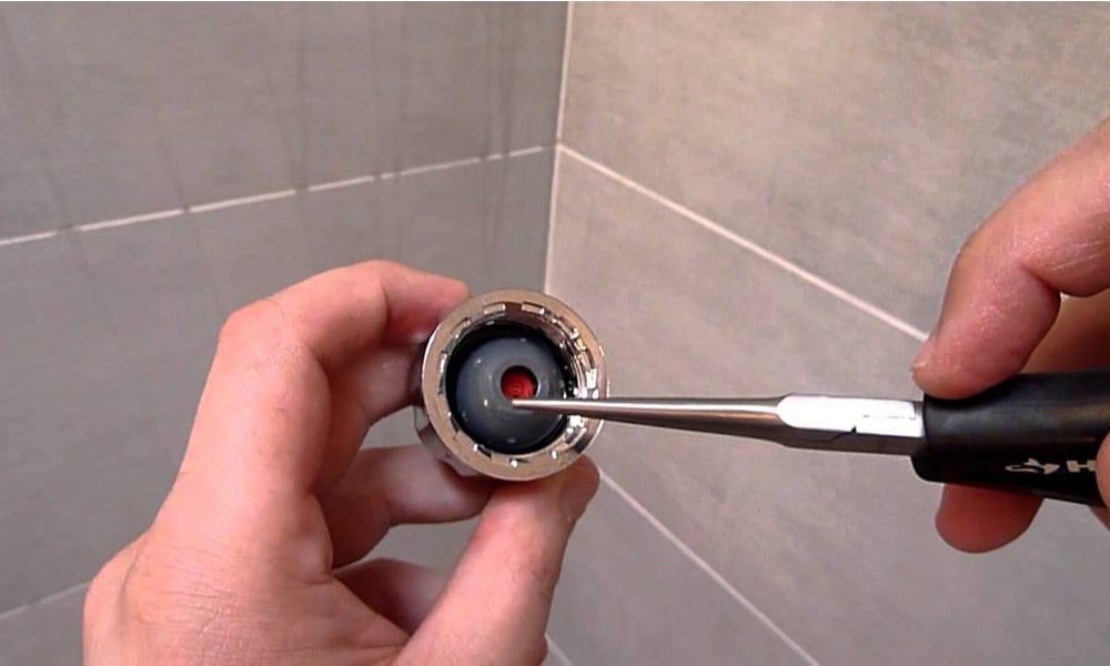 How to remove flow restrictor from moen handheld shower head