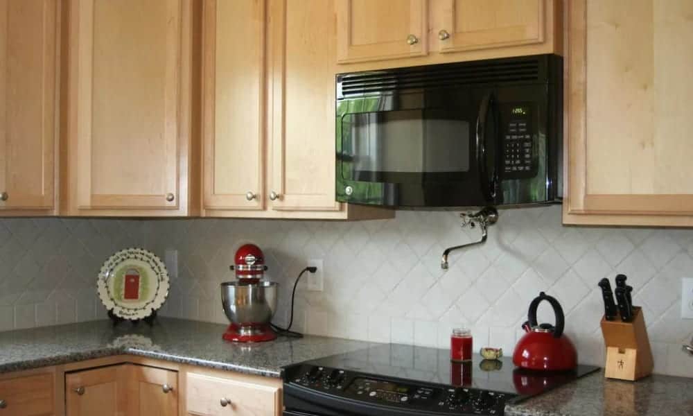 Diagonally placed backsplash white tiles