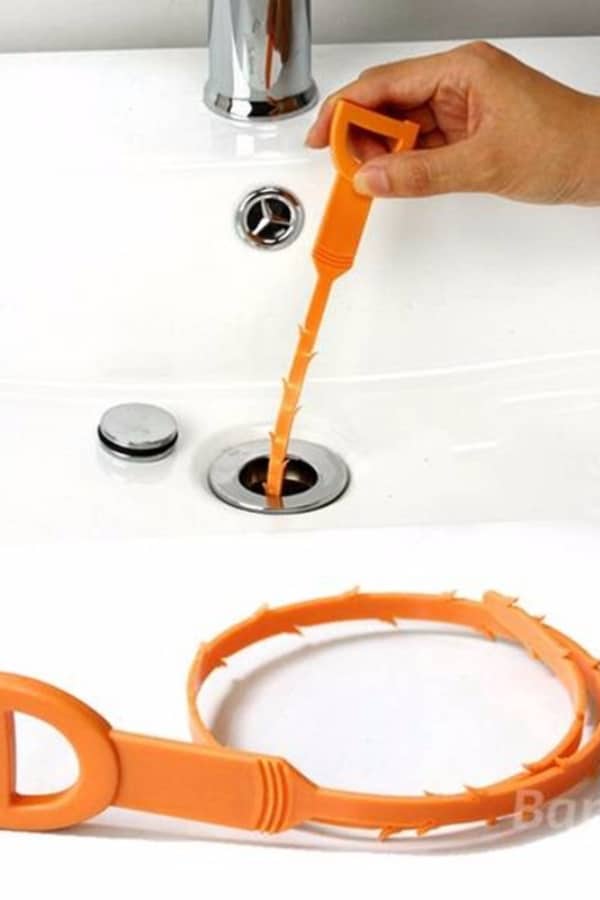 Use the hair removal tool to unblock the sink
