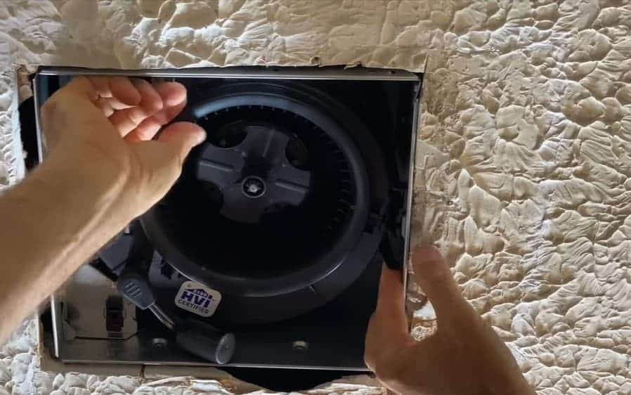 Slide the fan assembly into the housing