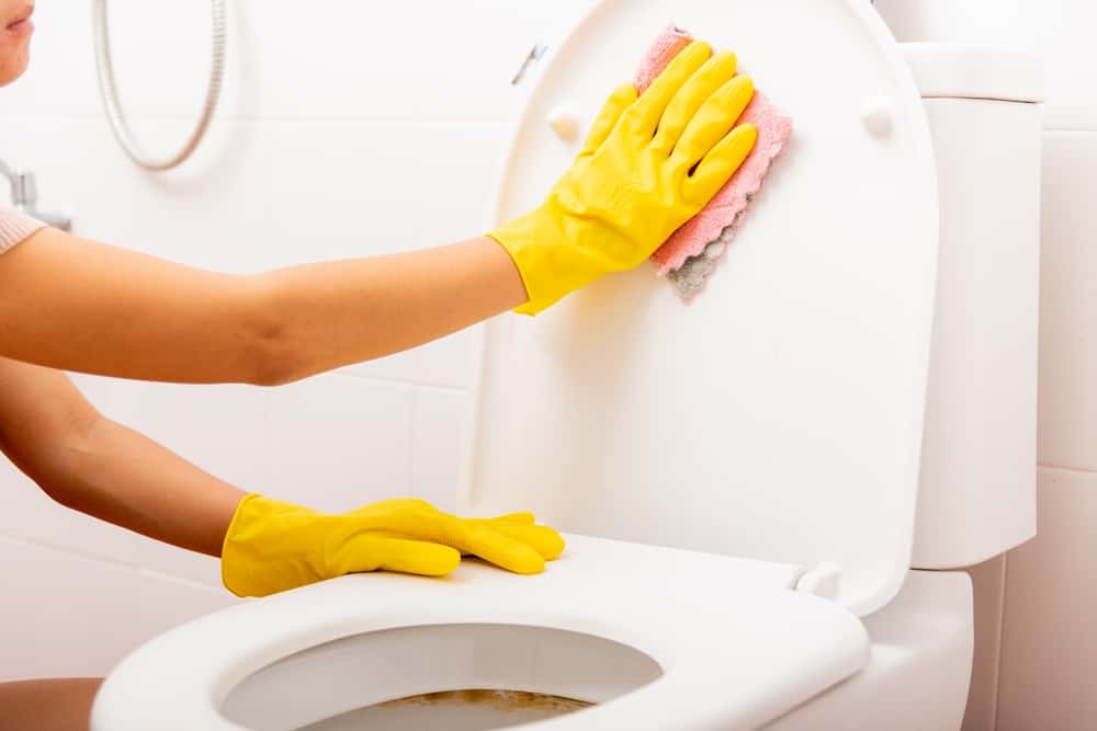 How can you avoid bleach turning your toilet seat yellow?